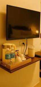 a shelf with food and a television on a wall at Perrera Guesthouse in Santa Ana +3 photos