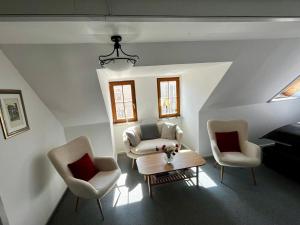 a living room with two chairs and a table at Fewo Charlotte in Weimar