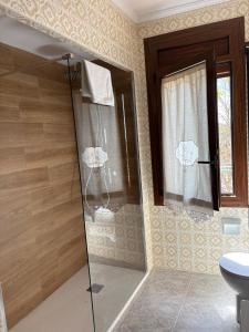 a shower with a glass door in a bathroom at CASA JESUS in Abiego +63 photos