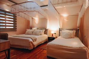 a bedroom with two beds and a window at Tano Bora Hotel in Sekenani +87 photos