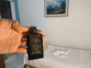 a person holding a watch in front of a table at Hotel Villa Real in Diamantina