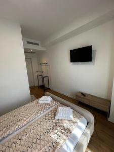 a bedroom with a bed and a flat screen tv at Una La Unica in Bihać