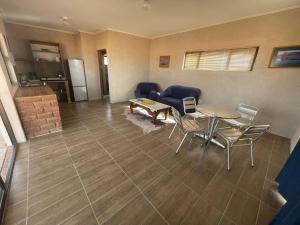 a living room with a table and chairs and a kitchen at 4BFarming Rest camp and Camping in Naris +31 photos