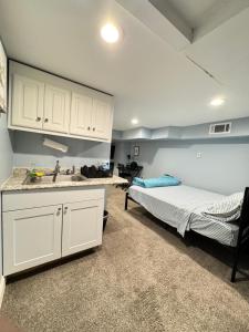 a kitchen with a bed and a sink in a room at Downtown Suite - Close to Topgolf, Horseshoe Casino, UM Baltimore in Baltimore
