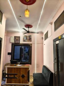 a living room with a tv and a couch at The SD hotel and restaurant in Bhopal
