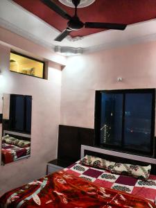 a bedroom with a bed and a ceiling fan at The SD hotel and restaurant in Bhopal
