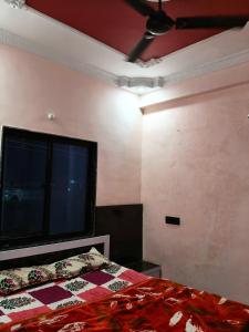 a bedroom with a bed and a large window at The SD hotel and restaurant in Bhopal
