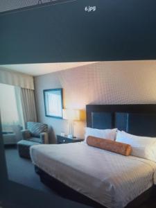 a hotel room with a bed and a chair at Shri ji hotel in Govardhan