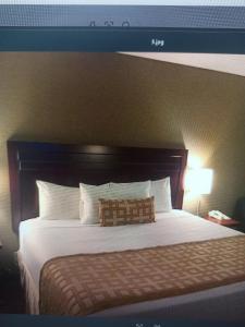 a bedroom with a large bed with a large headboard at Shri ji hotel in Govardhan