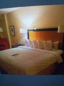 a hotel room with a large bed with white pillows at Shri ji hotel in Govardhan
