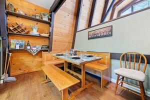 a dining room with a wooden table and chairs at Chief Peak in Fish Camp