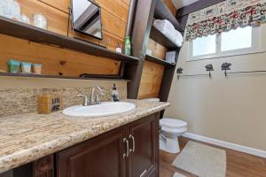 a bathroom with a sink and a toilet at Chief Peak in Fish Camp +16 photos
