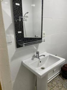 a white bathroom with a sink and a mirror at Shirin Ethno House Yurt Camp in Shirin +15 photos