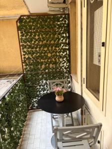 a table and chairs on a balcony with a green wall at B&B Da Simone in Battipaglia