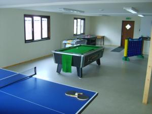 a room with a ping pong table and a pool table at Melbury Chalet in West Stour