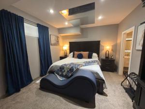 a bedroom with a large bed with blue curtains at Stay549 in Winnipeg +32 photos
