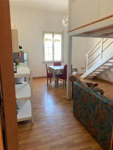 a living room with a couch and a dining room table at Casa vacanze Misilla in Marsala
