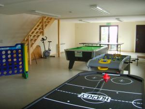 a play room with a pool table and a table at Melbury Chalet in West Stour