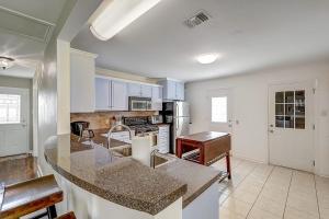 a kitchen with a large island in the middle at Wharf Cottage in Rockport