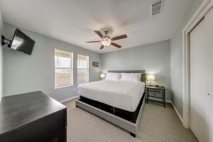 a bedroom with a bed and a ceiling fan at Wharf Cottage in Rockport