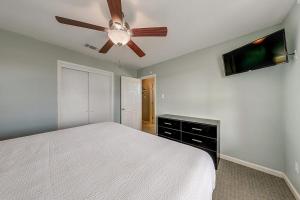 a bedroom with a bed and a ceiling fan at Wharf Cottage in Rockport