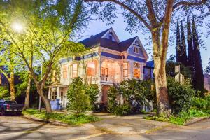 a large house with a blue roof on a street at IreneHouse Victorian INN in Sacramento +34 photos