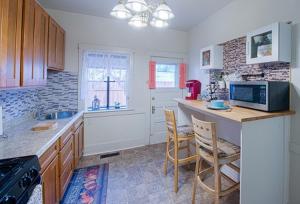 a kitchen with a counter and some chairs in it at IreneHouse Victorian INN in Sacramento