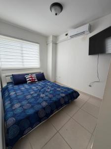 a bedroom with a blue bed in a room at An apartment with ocean views in Chiriquí +16 photos