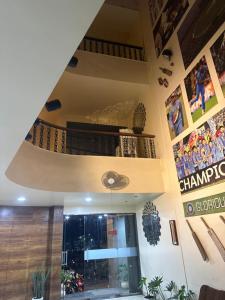 a lobby of a building with a sign on the wall at Hotel Gul-bahar in Satara