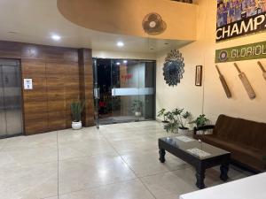 a lobby with a couch and a table in a building at Hotel Gul-bahar in Satara