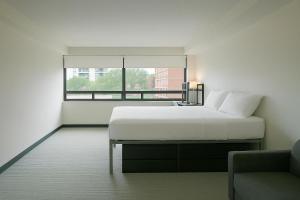 a white bedroom with a bed and a window at Parkside Student Residence Downtown Toronto in Toronto +27 photos