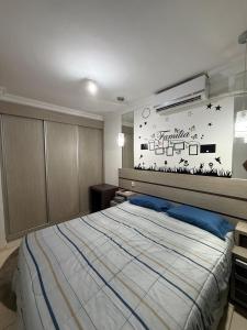 a bedroom with a bed and a wall with stars at Apartamento próximo Aeroporto Cuiabá in Várzea Grande +11 photos