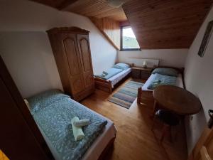 a small room with two beds and a table at Penzion Ranch FAH in Spišské Podhradie