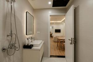 a bathroom with a sink and a shower and a sink at Residences A-25 in Hanoi