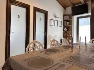 a dining room with a wooden table and chairs at DaVilla Sanremo - Entire Villa, Sea View & Pool in Pampara