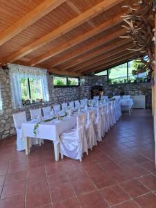 a room with white tables and white chairs at Penzion Ranch FAH in Spišské Podhradie