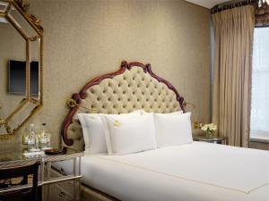 a bedroom with a large bed and a mirror at Rubens At The Palace in London +136 photos