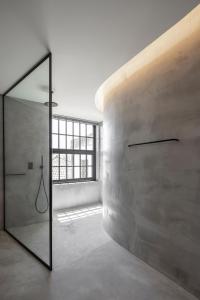 a bathroom with a shower and a mirror at Exmo Hotel by Olivia in Porto