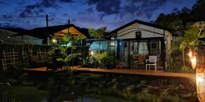 a house with a pool in front of it at Lespalm Resort by Vacayandco in Ban Thalat Choeng Thale