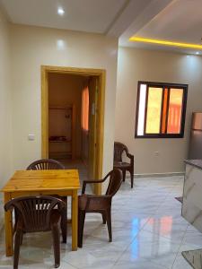 a dining room with a wooden table and chairs at Atlantic Coast Imsouane in Imsouane
