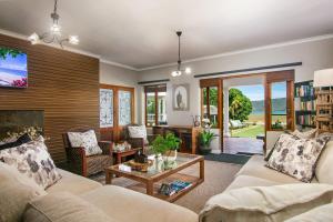 a living room with a couch and a table at Waterfront Lodge in Knysna