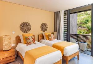 two beds in a room with a balcony at Panoramic View Mauritius in Ruisseau Créole +9 photos