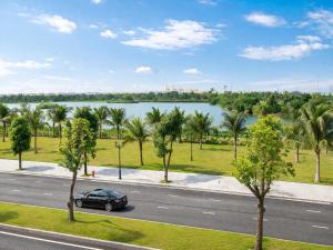 a car parked on a road next to a lake at Homemie in Binh Hai