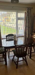 a table and chairs in a room with a window at Kathleen’s Haven in Causeway