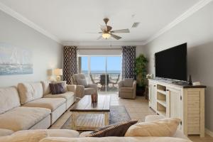 a living room with a couch and a flat screen tv at Marlin Key 2D in Orange Beach