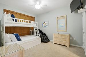 a bedroom with a white bunk bed and a dresser at Marlin Key 2D in Orange Beach +58 photos