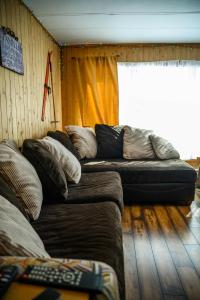 a living room with a couch and a window at Upper Floor - Mont-Video in Barraute