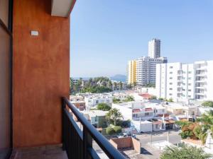 a balcony with a view of a city at Rooftop Pool & Steps to the Beach in Mazatlán