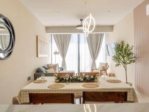 a living room with a table with flowers on it at Sunset Rooftop Pool Near the Beach in Mazatlán
