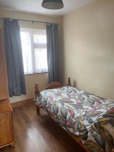 a bedroom with a bed with a quilt on it at Kathleen’s Haven in Causeway +9 photos